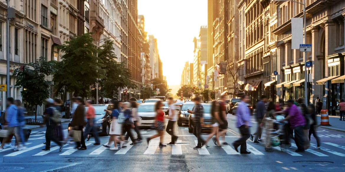 NYC street people crossing at sunset
